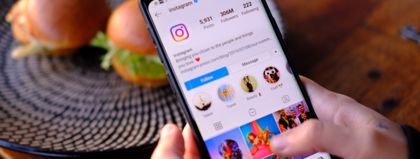 person on iPhone visiting Instagram for financial services company